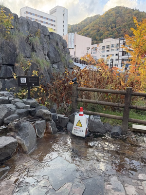 A waterfall in Jozankei, with a little kappa statue beside it